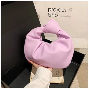 Detailed view of lavender pleated knot handbag with soft curved crescent texture