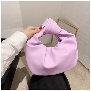 Detail of lavender knot handle handbag with soft pleated cloud-like faux leather texture