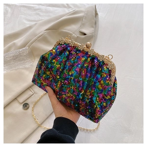 Detailed shot of a colorful sequined evening clutch bag with elegant golden floral clasp