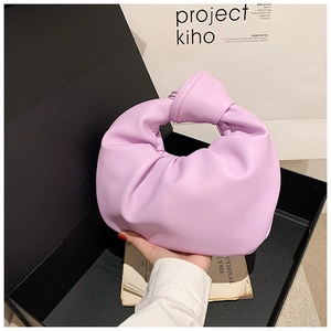 Detail of lavender pleated cloud bag with knotted handle in black presentation gift box
