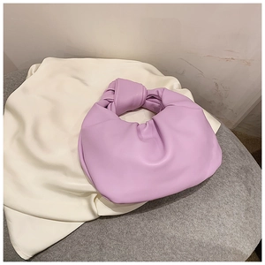 Detail of the lavender knotted handle and elegant pleated texture on the stylish handbag