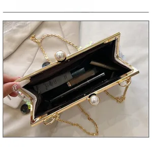 Detail view of the open sequin evening bag showing space for lipstick and makeup