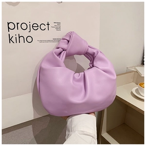 Close-up of lilac knotted handle and elegant pleated cloud bag design details