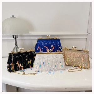 Detail of luxury evening clutch bags with sequins and feather fringe in four colors