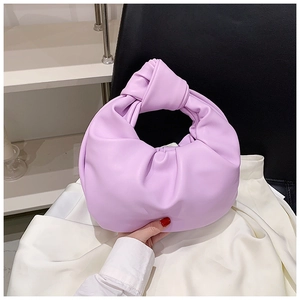 Detail of light purple pleated leather handbag with stylish knotted handle and soft texture