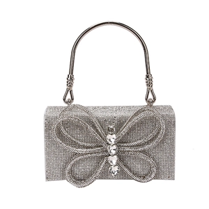 Elegant silver rhinestone evening handbag featuring a sparkling butterfly crystal clasp