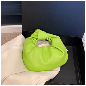 Detail shot of a lime green knotted hobo bag in a gift box with cloud-like pleats