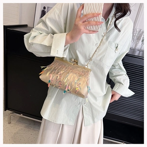 Detail of evening clutch bag with laser sequins and iridescent tassels on gold frame