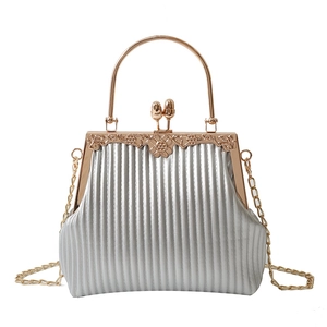 Elegant silver pleated clutch bag with rose gold metal handles and flower engraving