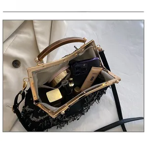 Detail view of the spacious inner compartment of this vintage fringe evening clutch bag