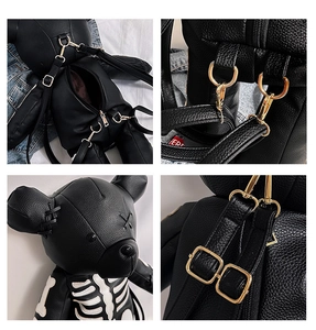Close-up of golden metal zippers and skeleton bone print on punk bear backpack