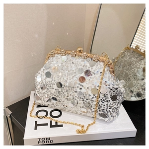 Détail de la pochette de soirée à paillettes argentées avec fermoir doré et perles