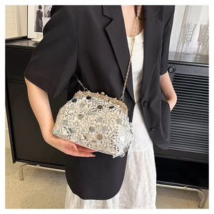 Vue détaillée du sac de soirée à paillettes argentées avec chaîne dorée et fermoir strass