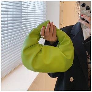 Detail of green soft leather knotted handle handbag with pleated crescent moon structure