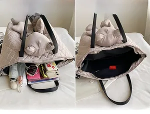 Quilted tote bag showing large capacity interior for umbrella and tablet