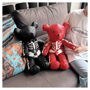 Close-up of gothic skeleton bone print on litchi texture leather plush bear backpack