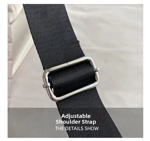 Detail showing an adjustable black nylon shoulder strap with a silver metal buckle