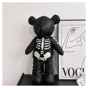 Detail of gothic teddy bear backpack in black litchi leather with white bone patterns