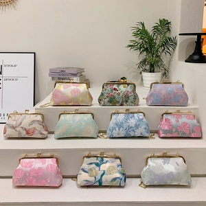 Vintage jacquard floral kiss-lock bags with gold chain straps in elegant tiered display