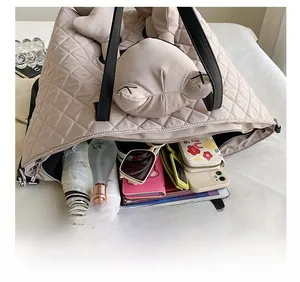 Beige quilted tote bag showing large interior space with plush toy and daily essentials