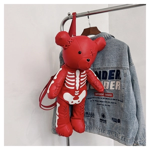 Detail of red leather teddy bear backpack with white skeleton print and punk laces