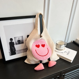 Beige knitted tote bag with pink plush heart-eye smiley face and cute stuffed feet