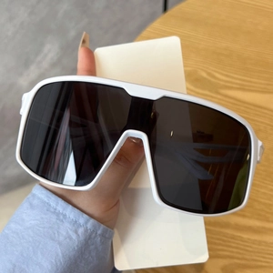 Detail of white wrap-around sunglasses frame with dark lenses for outdoor sports wear