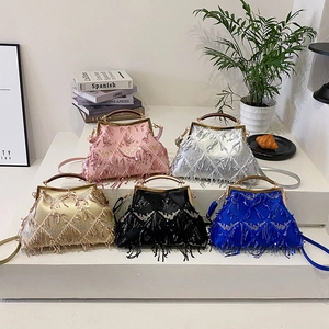 Sparkly sequin tassel evening bags in five colors on white display stands with metal handles