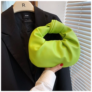 Detail of neon green knotted leather hobo bag with soft pleated design and trendy handle