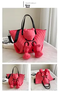 Detail view of the rose red quilted tote bag with a 3D cartoon plush and black straps