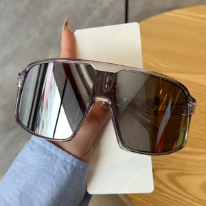 Detail of oversized purple rimmed sunglasses with silver gradient mirror lenses