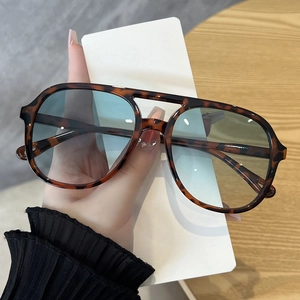Detail of vintage leopard print aviator sunglasses with double bridge and blue lenses