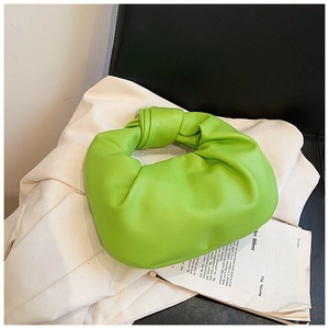 Close-up of the neon green ruched leather cloud bag featuring a knotted handle detail