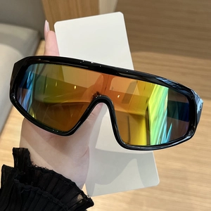 Detail of oversized shield sunglasses with thick black frame and rainbow gradient lens