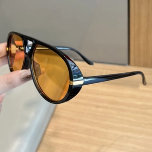 Retro oversized aviator sunglasses with orange lenses and gold metal temple accents
