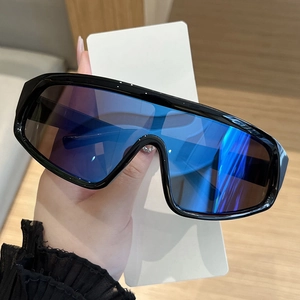 Detailed view of oversized wrap-around sunglasses with blue-purple iridescent lenses