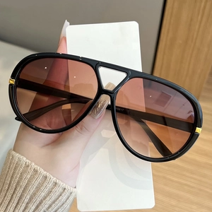 Classic aviator sunglasses with black frames and brown gradient lenses for women
