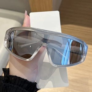 Detail view of oversized Y2K sunglasses with grey frames and silver mirrored lenses