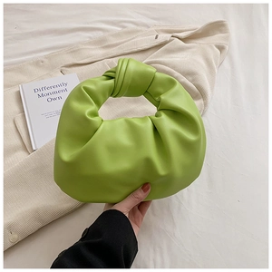 Detail showing high-quality light green pleated cloud bag with stylish knotted handle texture