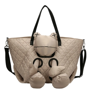 Large khaki quilted tote bag with cute plush doll and adjustable black shoulder strap