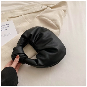 Detail of black knotted hobo bag with pleated soft faux leather and elegant texture
