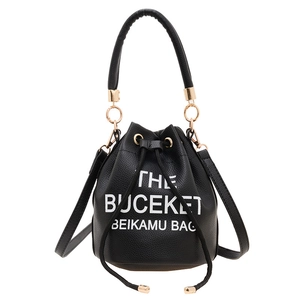 Classic black drawstring bucket bag with large capacity and elegant gold hardware