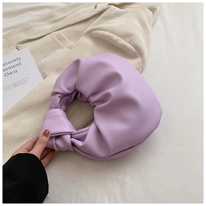 Close-up of knotted handle and pleated lavender leather texture on cloud handbag