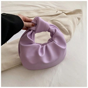 Detailed view of lilac knotted handle handbag with soft pleated cloud texture design