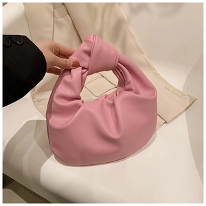 Detail of the pink knotted handle and pleated leather texture on a cloud bag