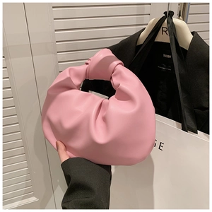 Close-up of pink knotted crescent bag made of soft synthetic leather for fashion