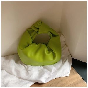 Detailed view of neon green knotted handle and premium ruched leather of the cloud bag