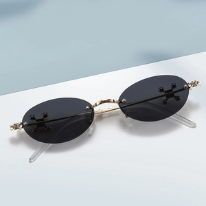 Fashionable rimless oval sunglasses for women with gold metal temples and diamond accents