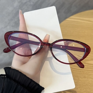 Detail of red cat-eye glasses frame with semi-transparent finish and metal rivets
