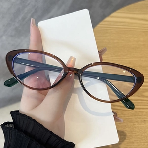 Detail of vintage cat-eye glasses frame in dark brown and forest green colors
